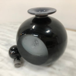 Nick Wirdnam round with one edge flat black art glass scent bottle. Signed underneath In good original condition.