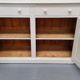 Australian painted two door kitchen hutch display and buffet cabinet. The top section has hooks and shelves. The bottom has two drawers along with cupboard space for added storage. In good original condition.