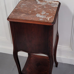 French Rosewood inset marble top single bedside cabinet with one drawer and one cupboard on elegant legs. Would also make a practical and stunning table lamp. It is in good original detailed condition.