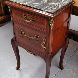 Appealing Louis XV style high quality bedside cabinets with black Portoro marble top and bronze mounts. They have been sourced from France and are in good original condition.