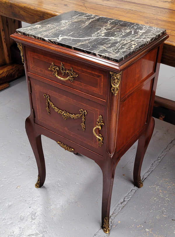Appealing Louis XV style high quality bedside cabinets with black Portoro marble top and bronze mounts. They have been sourced from France and are in good original condition.