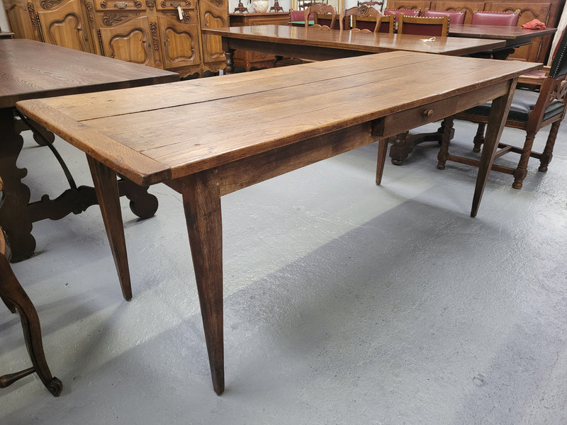 Provincial 19th Century French Oak rustic farmhouse table with tapered leg and single drawer. It has been sourced from France and is in good original detailed condition. 