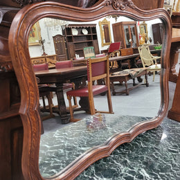 French Louis XV style carved Oak wall mirror. It is in good original detailed condition and has been sourced from France.