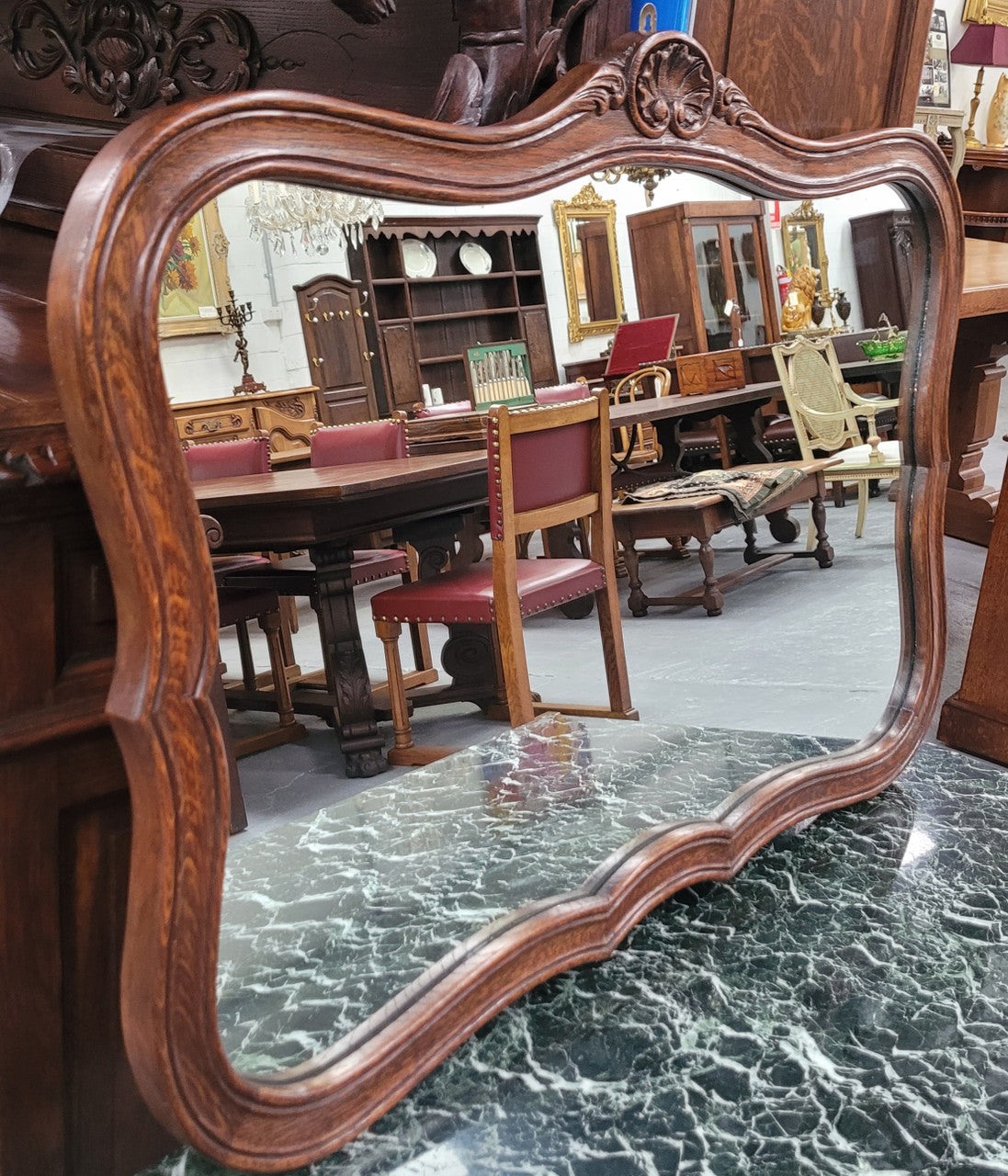 French Louis XV style carved Oak wall mirror. It is in good original detailed condition and has been sourced from France.