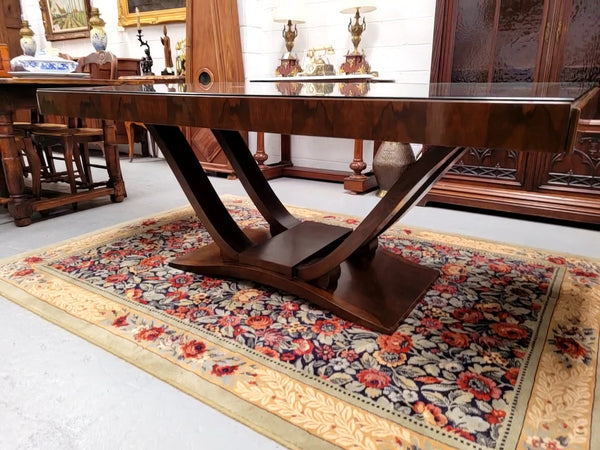 French Art Deco Figured Walnut dining table and six chairs. This stylish table also comes with a glass top and can be used with or without it. The chairs are very comfortable and the table can also fit another two chairs at either end making it a 6-8 seater. The table is in good original detailed condition with character marks to the top of table as shown in the pictures. This table and six chairs have been sourced locally.