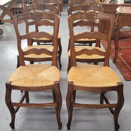 Set of six Louis XV style French Oak rush seat dining chairs. They are in good original detailed condition.