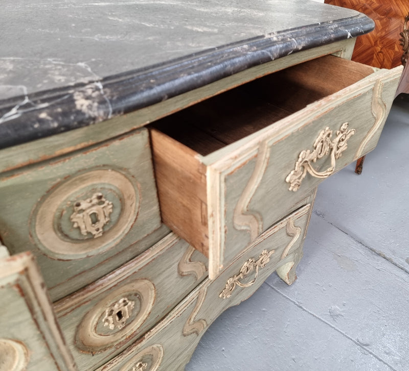Early 19th Century Louis XIV style faux marble top and painted base commode. It is of large proportions and has four drawers. In good original detailed condition.