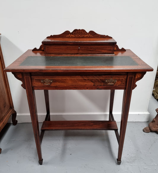 Edwardian Sheraton style desk with a tooled leather insert top with beautiful marquetry inlay. In good original detailed condition. Circa: 1910's