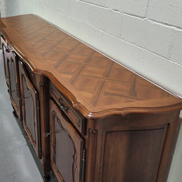 Walnut Louis XV style parquetry top four door sideboard with beautiful carving. Plenty of storage space and it is in good original detailed condition.