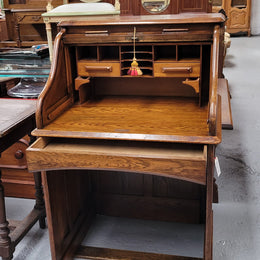 Charming petite English Oak fitted roll top desk. It has a very lovely fitted interior and a drawer at the front ideal for a unit or apartment. Sourced locally and in good original detailed condition.