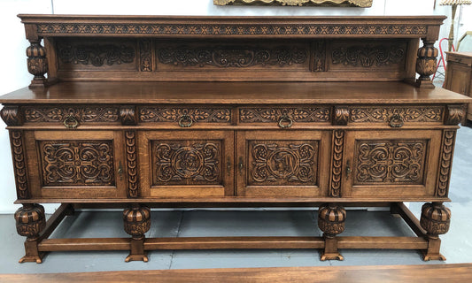 French Oak beautifully carved Renaissance style sideboard with four drawers. Beautiful wax finish and is in good original detailed condition.