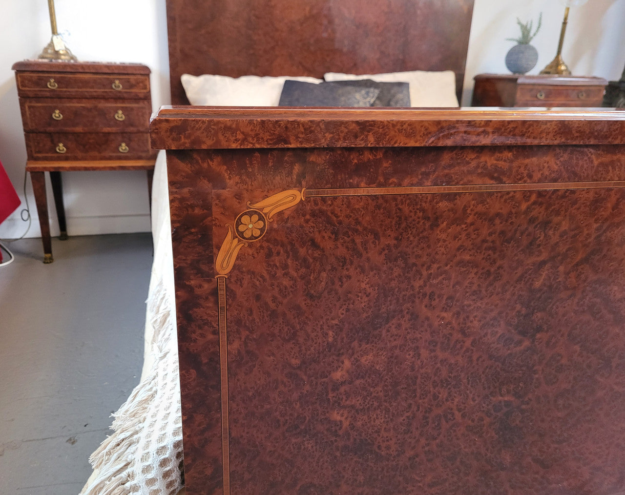 French Art Deco bedroom suite consisting of queen size bed in Amboyna wood and featuring pretty inlay. It comes with a matching pair of bedsides. It is a very stylish and high quality suite. It has been sourced from France and is in good original detailed condition.