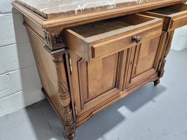 Stunning French walnut Henry II style marble top side cabinet with two drawers and two shelves inside. In good original detailed condition.