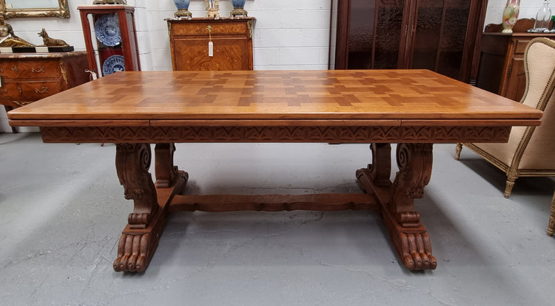 Amazing French Oak Renaissance style parquetry top extension table. Beautiful parquetry top and amazing detailed carvings on the legs. It extends to 306 cm long when fully extended. Sourced from France and in good original detailed condition.