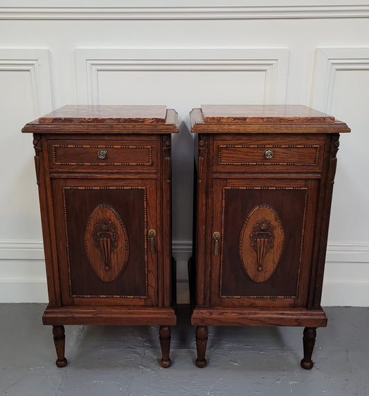 Pair of French Art Deco Oak and rouge inset marble top bedside cabinets. They have one drawer and one cupboard with elegant carving on the door. They have been sourced from France and are in good original detailed condition.
