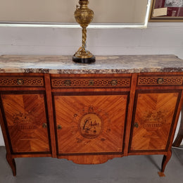 A high quality 19th Century French marquetry inlaid Kingwood marble top credenza. It has an attractive solid marble top and decorative marquetry inlay throughout. It has plenty of storage space with three drawers and three doors. It has been sourced from France and is in good original detailed condition.