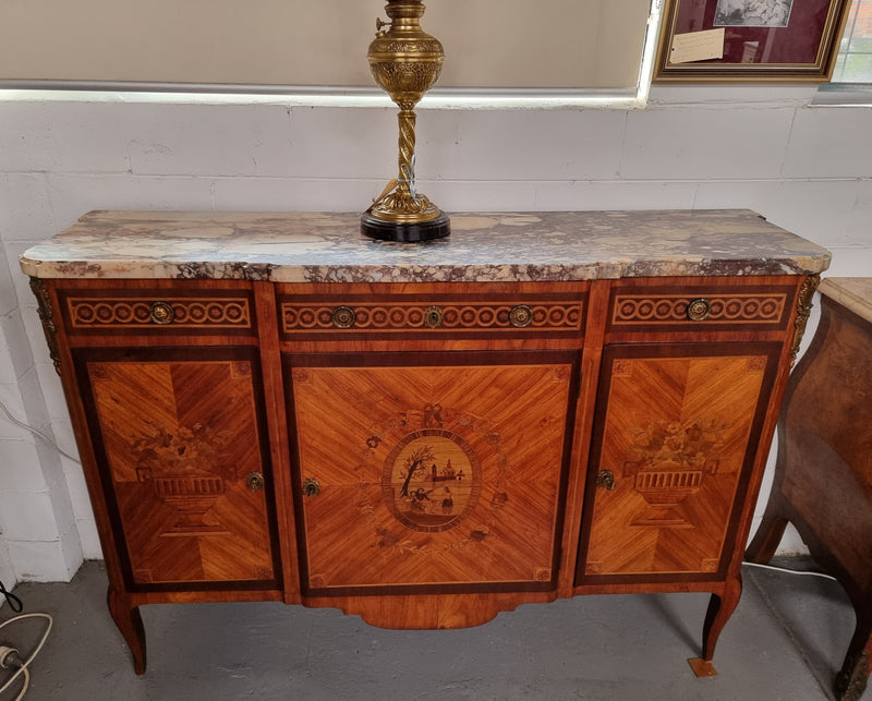 A high quality 19th Century French marquetry inlaid Kingwood marble top credenza. It has an attractive solid marble top and decorative marquetry inlay throughout. It has plenty of storage space with three drawers and three doors. It has been sourced from France and is in good original detailed condition.