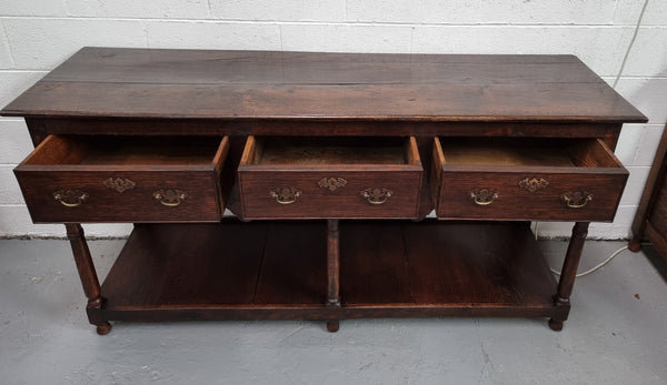 Antique 19th Century English dark Oak three drawer Dresser with brass handles and in good original condition.