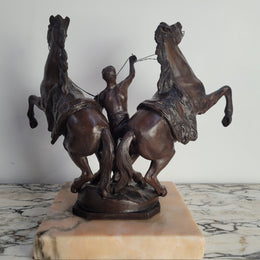 French Art Deco cold painted bronze metal marley horses style statue on a marble base. It is in good condition.
