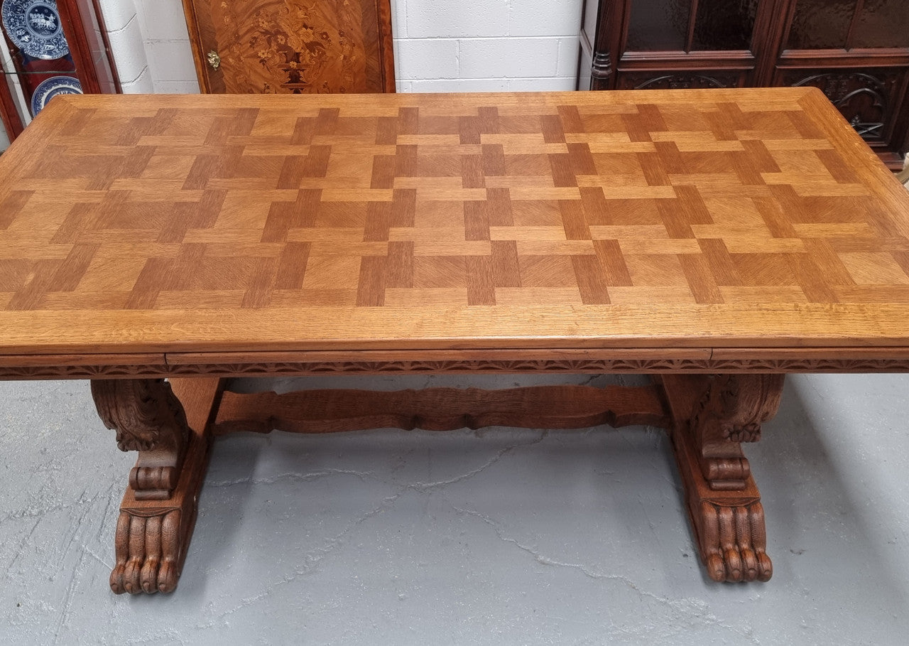 Amazing French Oak Renaissance style parquetry top extension table. Beautiful parquetry top and amazing detailed carvings on the legs. It extends to 306 cm long when fully extended. Sourced from France and in good original detailed condition.