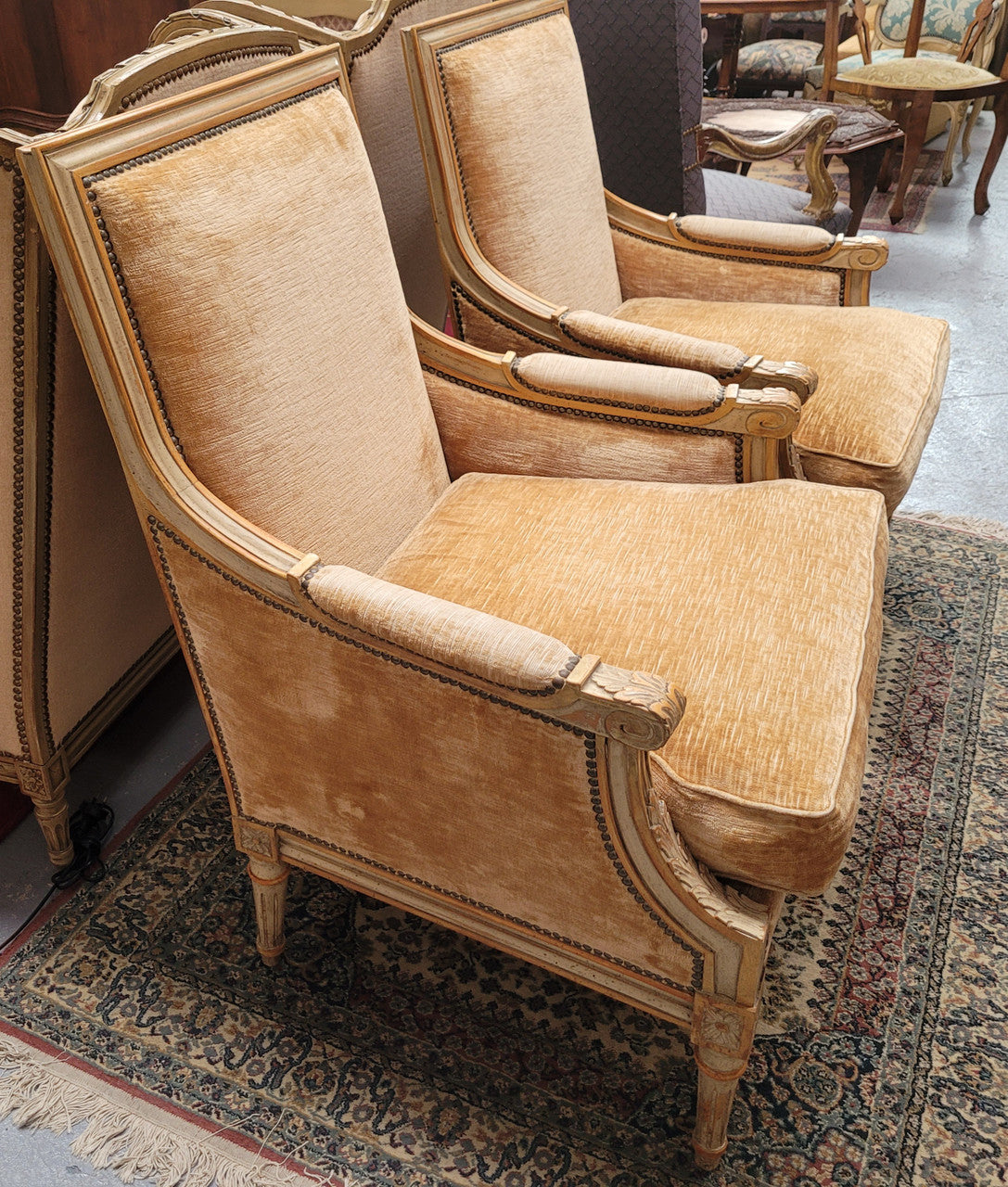 Pair of Louis XVI style painted arm chairs with carving & fluted legs. They have been sourced from France and the fabric is in good used original condition. Please view photos as they help form part of the description.