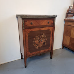 Louis 16th style marquetry inlaid side cabinet with a pierced brass gallery surrounding a marble top. It has two doors open up to storage with one shelf and a drawer above that. In good original detailed condition.