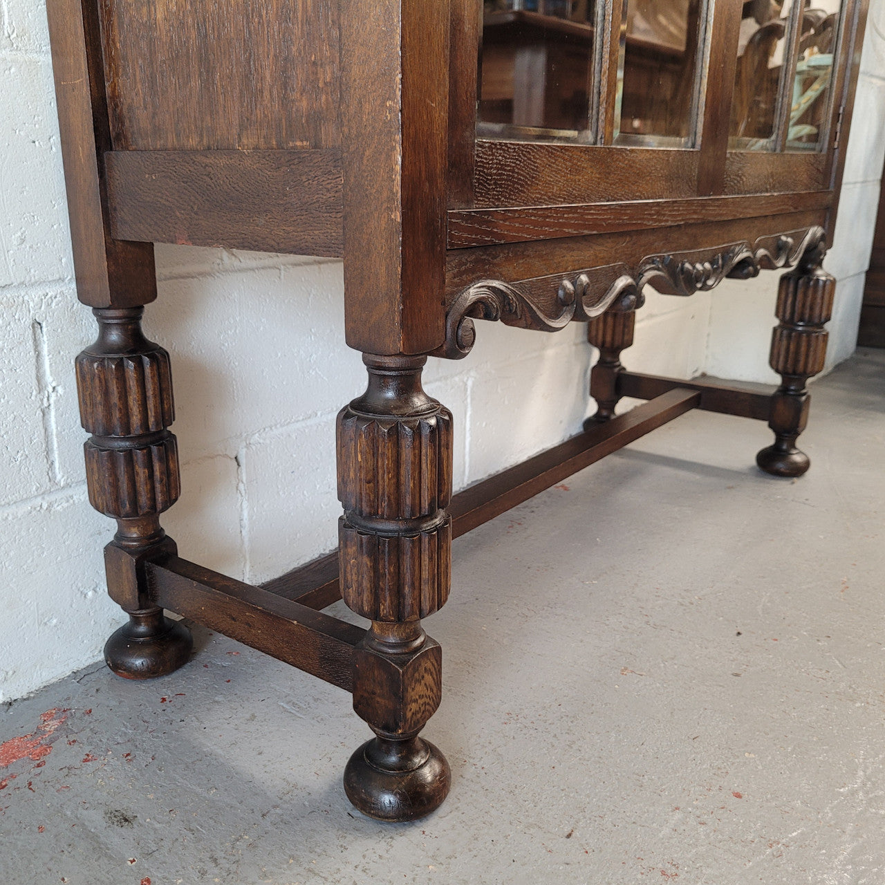 Tudor oak 2 door astral glaze and beveled glass bookcase.  Good original condition. Circa 1930s.