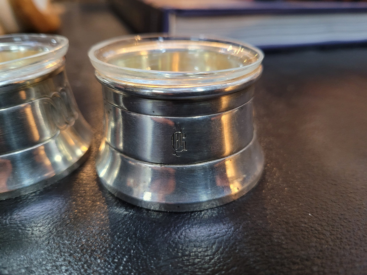Pair antique silver salt cellars with liners. Stamped “800” 80g. 4.5cm Diam & 3cm Height. In good condition please view photos as they help form part of the description.