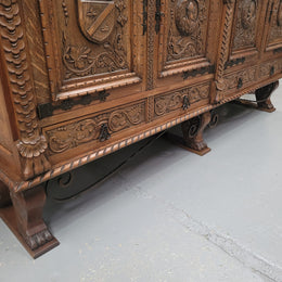 Large French Oak Renaissance style four door sideboard/buffet. Great decorative item with amazing carvings and stunning iron work on base. It is in good original detailed condition. Can pull apart completely making it easier to move.