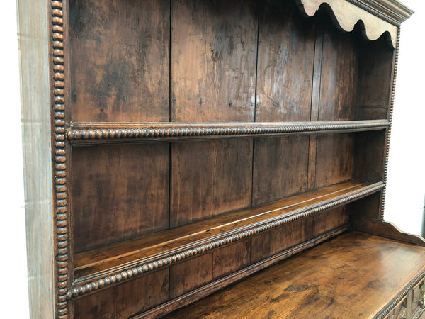 Fabulous Antique Tudor style Oak kitchen dresser with two drawers and two shelves. It is in good original detailed condition.