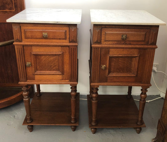 A lovely pair of French Oak, marble top bedside cabinets with a cupboard and drawer in good original condition.