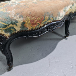 A Substantial Antique 19th Century Louis XV style ebonized serpentine front settee. The fabric is in used condition showing use and could be used as is or reupholster.
