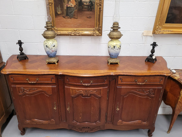 French Oak Louis XV style three drawer three door parquetry top sideboard. It has been sourced from France and is in good original detailed condition.