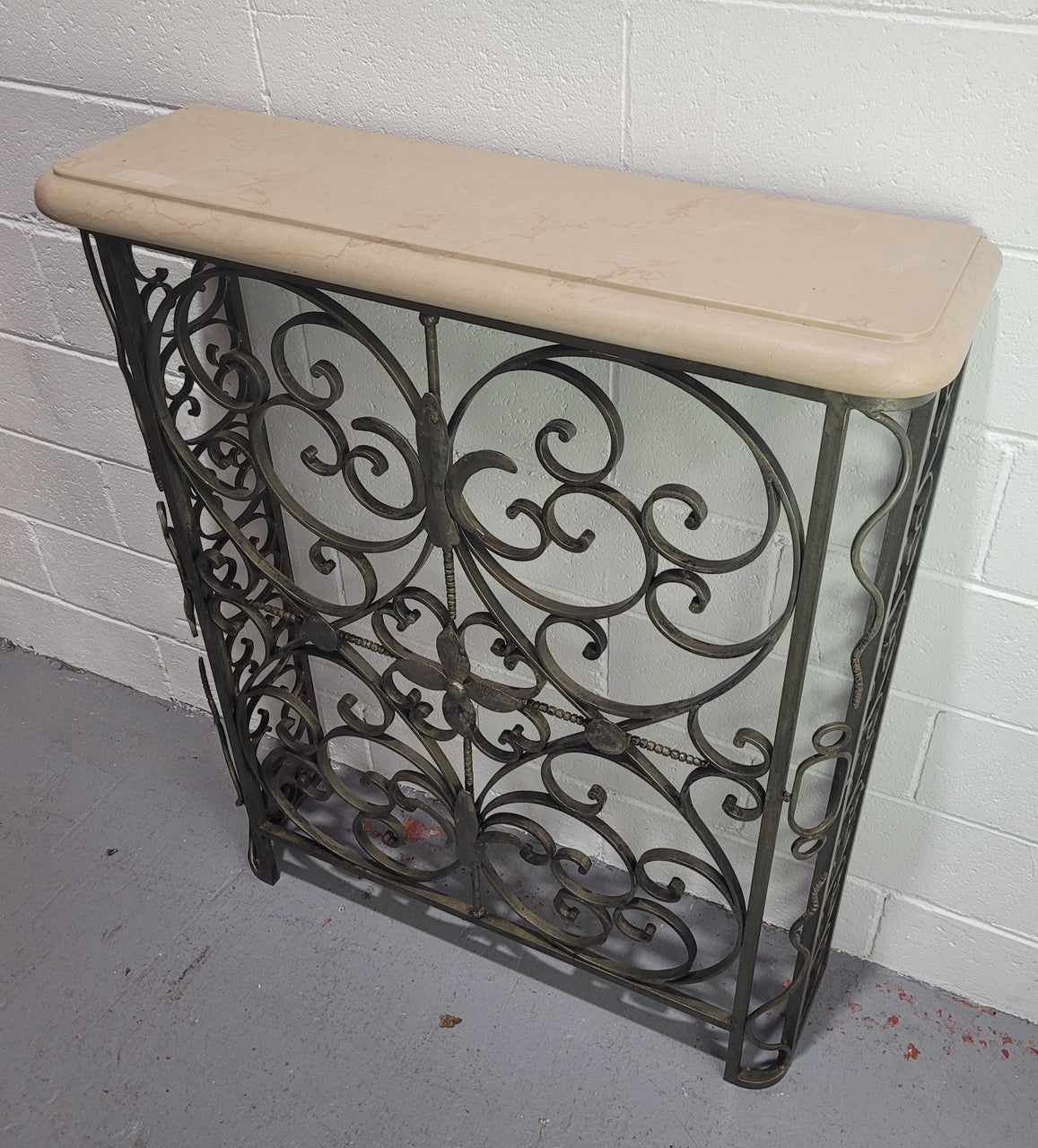 Stunning Art Deco wrought iron and marble top console table. It has amazing decorative iron work at the bottom and a beautiful marble top. It is in good original detailed condition.