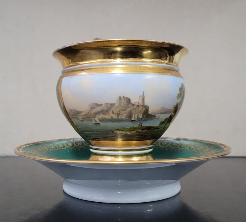 “Old Paris Porcelain” large cup and saucer with hand painted river landscape featuring castles. Gilt and enamel decoration. Circa: early 19th Century. In good original condition please view photos as they help form part of description.