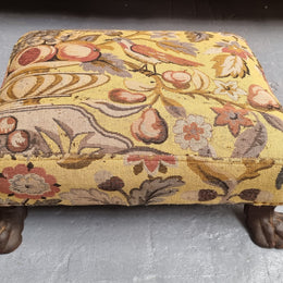 Lovely Upholstered Georgian footstool with feet. It has been sourced locally and is in good original condition.