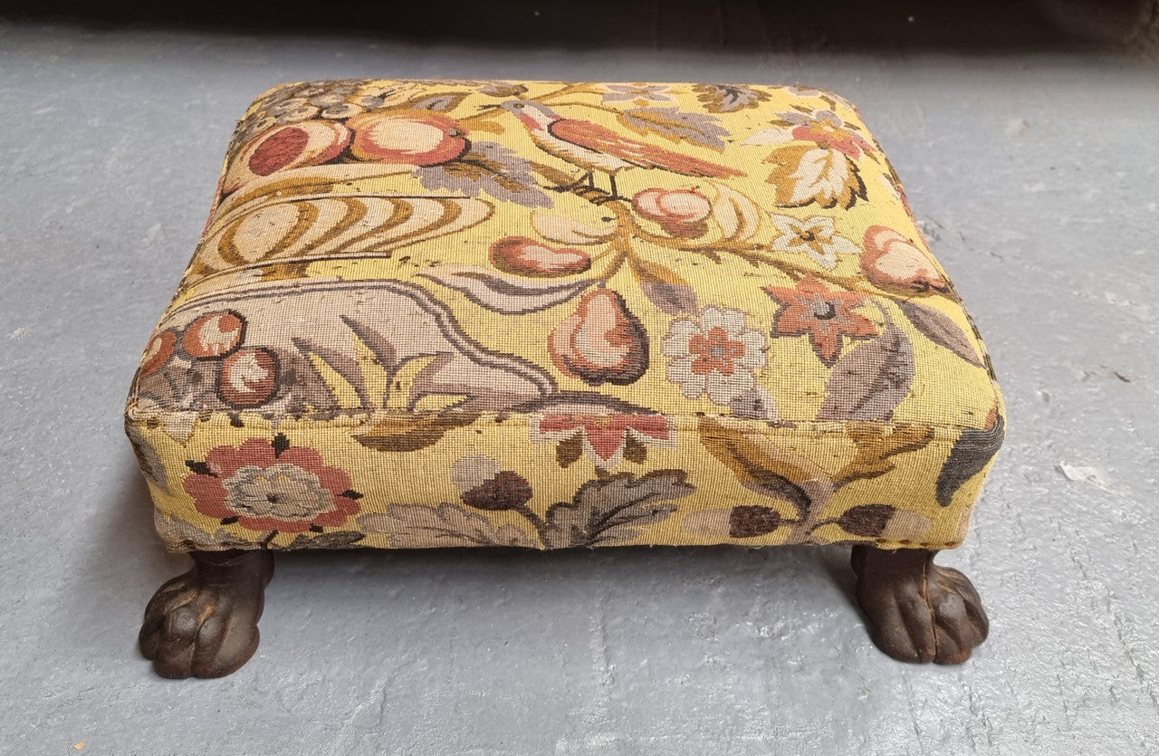 Lovely Upholstered Georgian footstool with feet. It has been sourced locally and is in good original condition.