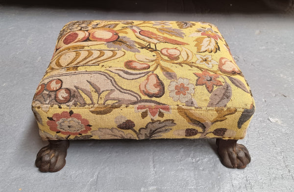 Lovely Upholstered Georgian footstool with feet. It has been sourced locally and is in good original condition.