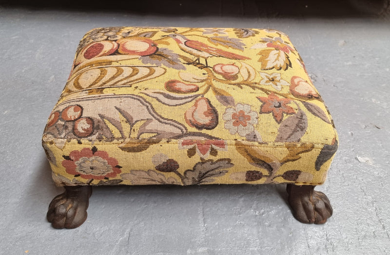 Lovely Upholstered Georgian footstool with feet. It has been sourced locally and is in good original condition.