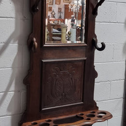 A beautiful Henry II style narrow French Oak hall stand. It has beautiful decorative carvings as well as 8 wooden hooks and storage for umbrellas and walking sticks. In good original detailed condition.