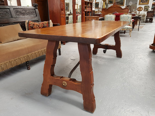 French Oak Spanish style dinner table with beautiful simple iron work underneath. Table top is in good original condition with character marks and has a wax finish. Circa 1930.
