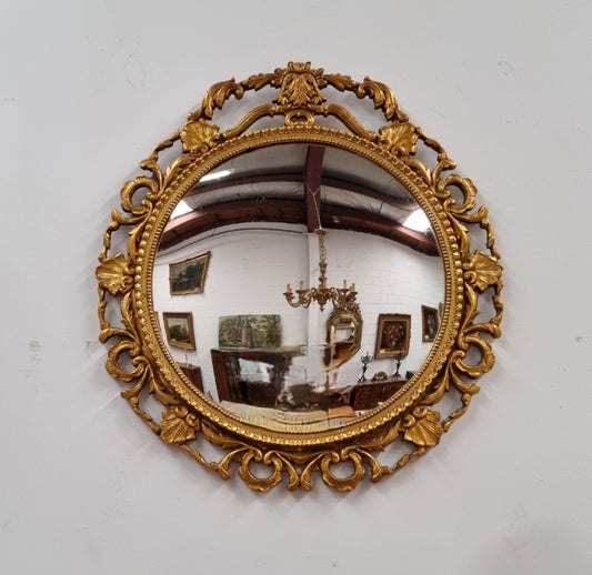 Vintage large round ornate convex mirror. Lovely gilt decoration around and is in good original condition.