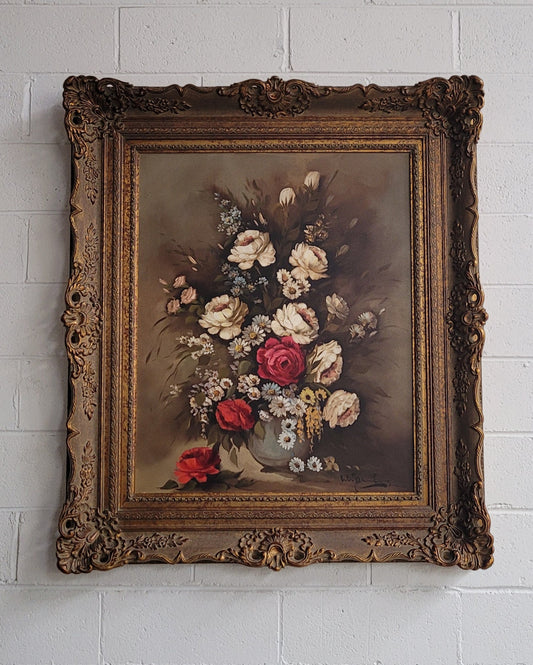 Attractive French floral oil on canvas - signed. Mounted in a stunning patterned gilded frame. It is in good original detailed condition.