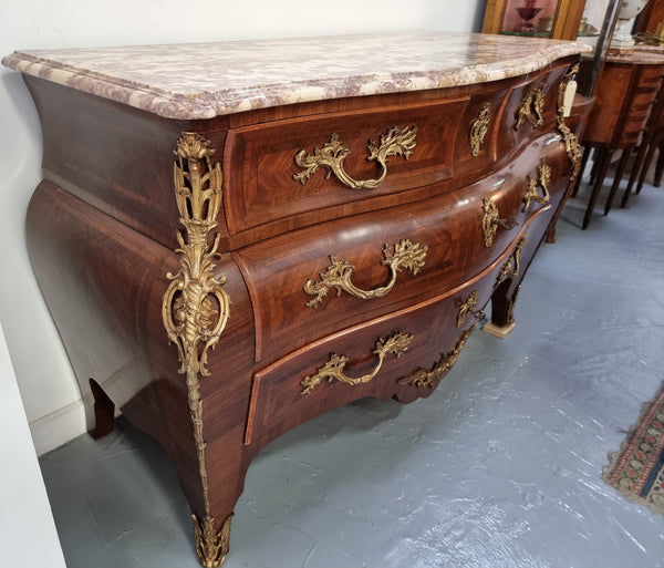 Grand French bombe shape Rosewood & Walnut marble top commode with beautiful ormolu mounts. It has two smaller drawers at the top and two larger drawers at the bottom. In good original detailed condition.