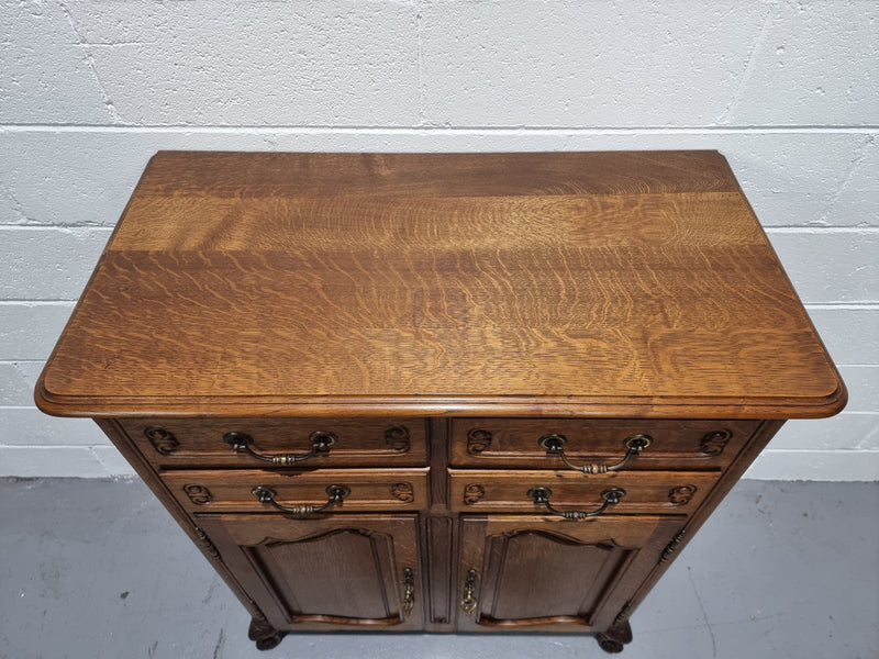 French Oak Louis XV style side cabinet. It has three drawers in total, two small drawers and one deep drawer. In good original detailed condition.