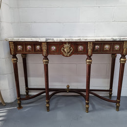 Vintage Mahogany marble top console table with matching mirror. Both with inset limoge panels surrounded by gilt brass. Highly decorative and in good original detailed condition. Circa 1950.