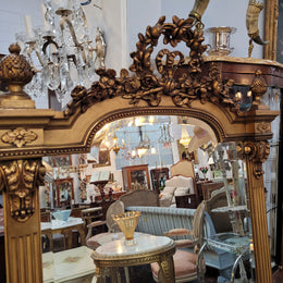 French Louis XVI style Napoleon III (1870’s) gilt mantle mirror. Beautifully carved and decorated with original bevelled mirror showing signs of age. It is in good original detailed condition and has been sourced from France.