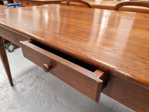 Antique French Oak Farmhouse table in fully restored condition. Features a single drawer and tapered legs.