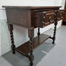 Lovely dark oak small Jacobean style two drawer side cabinet with barly twist legs and lovely carved details. In good original detailed condition.