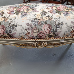 Antique painted Louis XV style upholstered stool. It has lovely floral upholstery that is in good condition with no tears. It is in good original detailed condition.